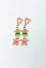 A pair of dangling holiday-themed earrings. Each earring features a pink and white striped candy cane stud, a small gingerbread man in a green outfit, and a larger gingerbread man in a pink outfit.