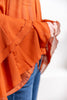 Close up of a lettuce hem tiered ruffle cuff of blouse.