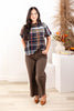 A woman modeling a short-sleeve plaid top with brown wide-leg pants and brown pointed-toe heels.