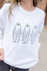 A person wearing a white crewneck sweatshirt with a graphic of three simple black ghost outlines on the front, paired with dark jeans.