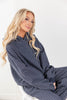 A woman wearing a navy blue and white pinstriped hoodie lounge set.