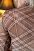 Close-up of a person's back wearing a sheer brown plaid mesh top with white intersecting lines.