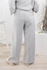 A woman from behind wearing heathered gray wide-leg pinstripe lounge pants with a drawstring waist and back pockets.