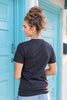 View of woman from behind wearing a black short sleeve t-shirt