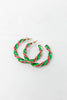 A pair of large hoop earrings with a twisted candy cane design in green, red, and white, featuring gold-tone posts.
