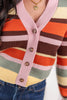 Close up of a striped cardigan sweater with pink, orange, brown, yellow, and sage green stripes.