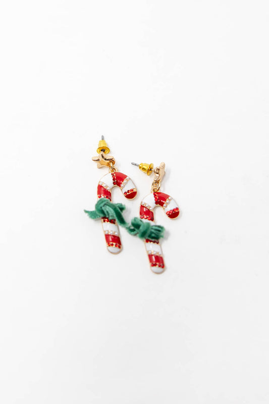 Dangling candy cane earring with a gold star stud, a red-and-white striped candy cane charm, and a velvet ribbon tied around it.