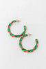 A pair of large, twisted hoop earrings with a candy cane pattern, featuring green and red enamel stripes with gold-tone metal posts.