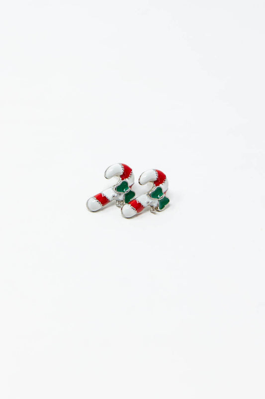 A pair of small candy cane-shaped earrings with white enamel, red stripes, and green bow detail.