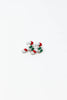 A pair of small candy cane-shaped earrings with white enamel, red stripes, and green bow detail.