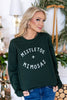A woman wearing a dark forest green crewneck sweatshirt with 'MISTLETOE + MIMOSAS' printed in white on the front.