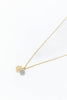 A delicate gold chain necklace featuring two snowflake-shaped pendants, one in yellow gold and one in silver.