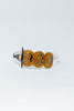 A silver-toned bracelet featuring three glittery orange jack-o'-lantern faces with black eyes and mouths, set against a plain white background.
