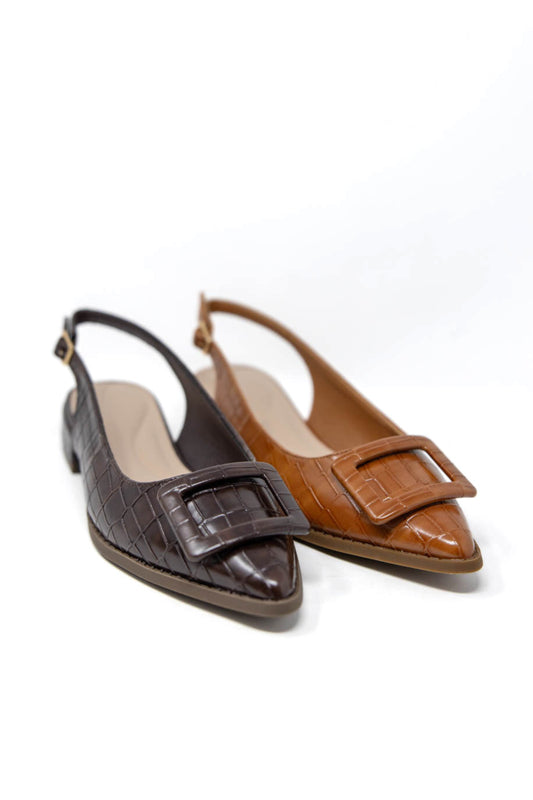 A pair of pointed-toe slingback flats on a white background, featuring one dark brown crocodile-embossed shoe and one tan crocodile-embossed shoe, both with a square buckle detail on the toe.