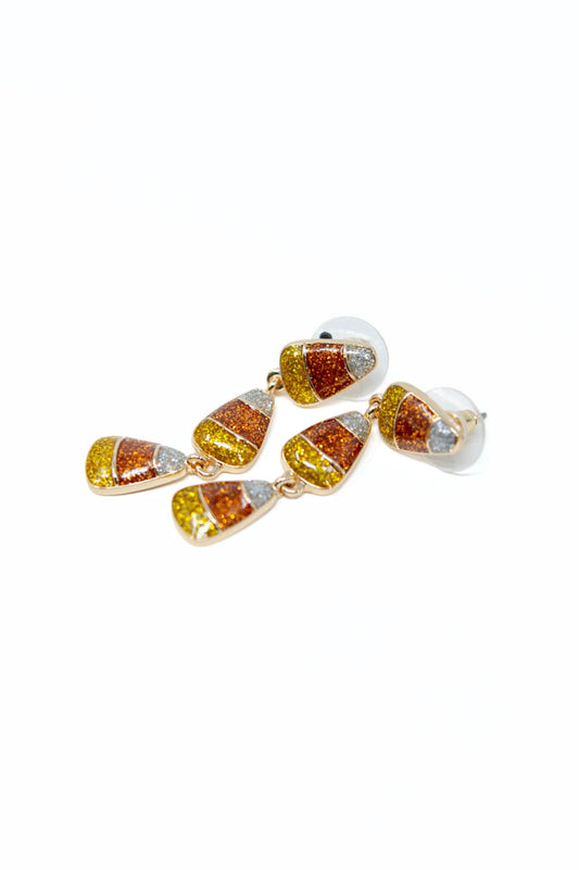 A pair of dangling earrings with small triangular gold-tone charms filled with glittery orange, yellow, and white sections, shown on a plain white background.