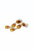 A pair of dangling earrings with small triangular gold-tone charms filled with glittery orange, yellow, and white sections, shown on a plain white background.