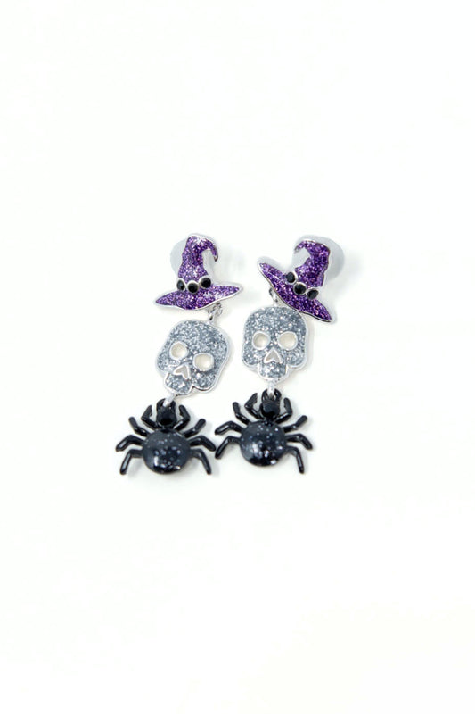 Three pairs of Halloween-themed stud earrings on a white background: purple witch hats, silver sugar skulls, and black spiders.