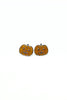 A pair of small pumpkin-shaped stud earrings with glittery orange bodies and silver-toned metal outlines, shown on a plain white background.