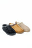 Three slip-on mule slippers shown on a white background: one black, one tan, and one light beige, each with decorative trim around the opening.