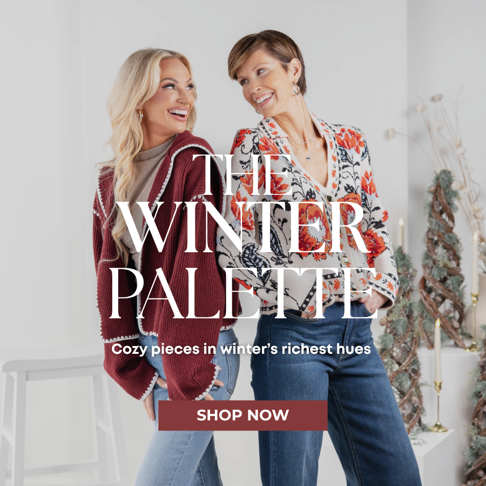 Women's winter fashion collection featuring cozy burgundy cardigans, floral sweaters, and stylish denim jeans in rich seasonal colors at Charming & Main.